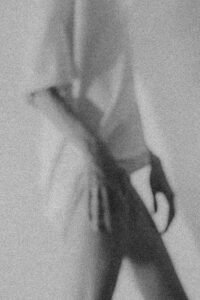 Blurred silhouette of a person in black and white, creating an abstract and artistic feel.